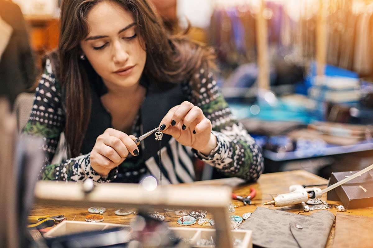 woman learning how to make jewelry