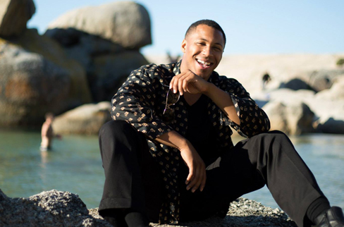 Prince sitting on a beach in South Africa