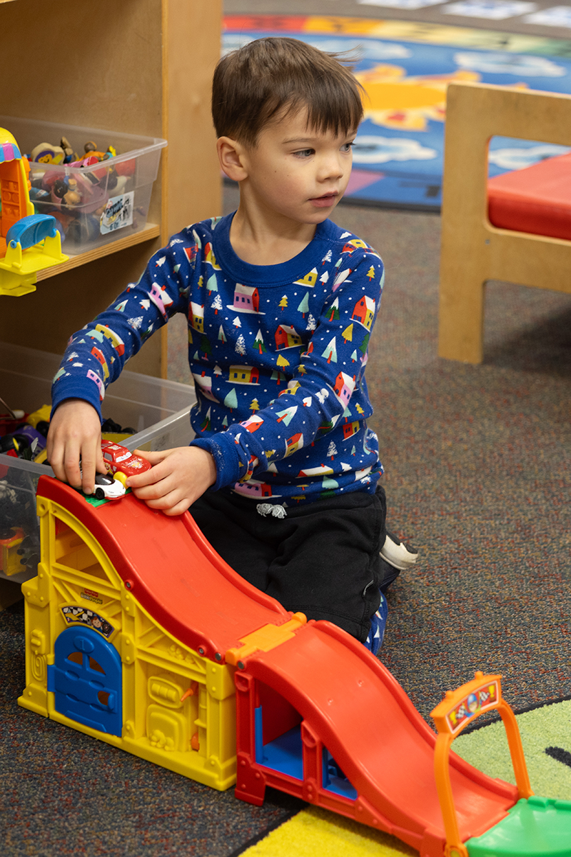 Boy plays with car