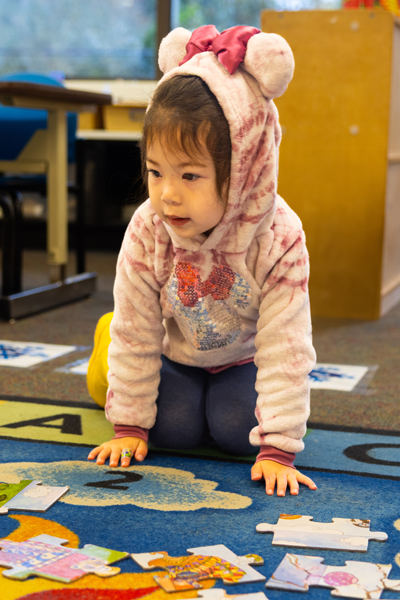 Bi-Racial Girl works on Puzzle