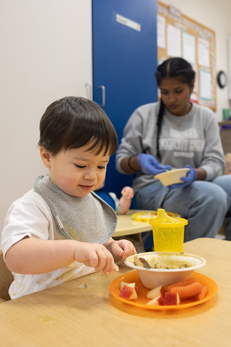 Toddler eats breakfast