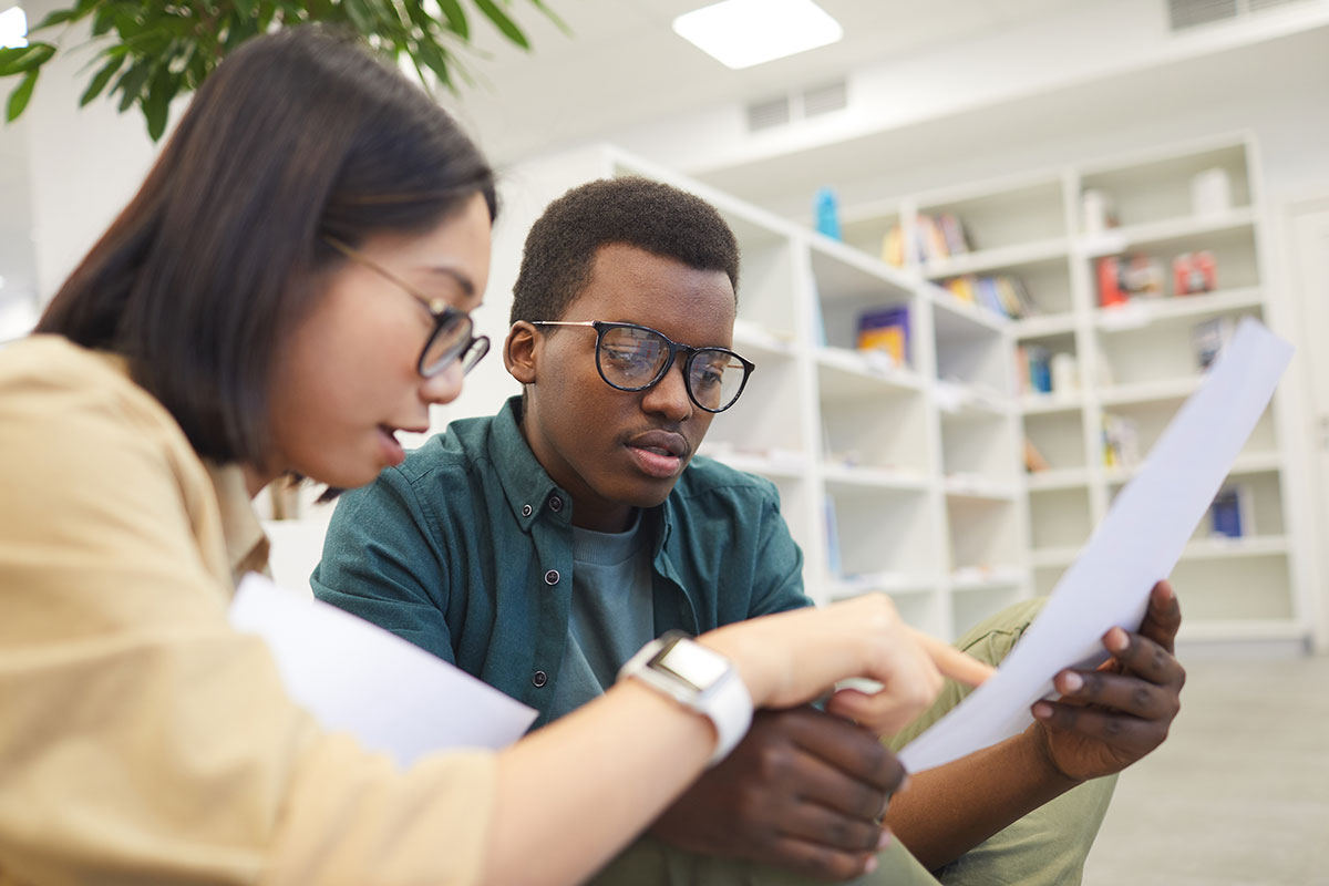 two students working together in a library