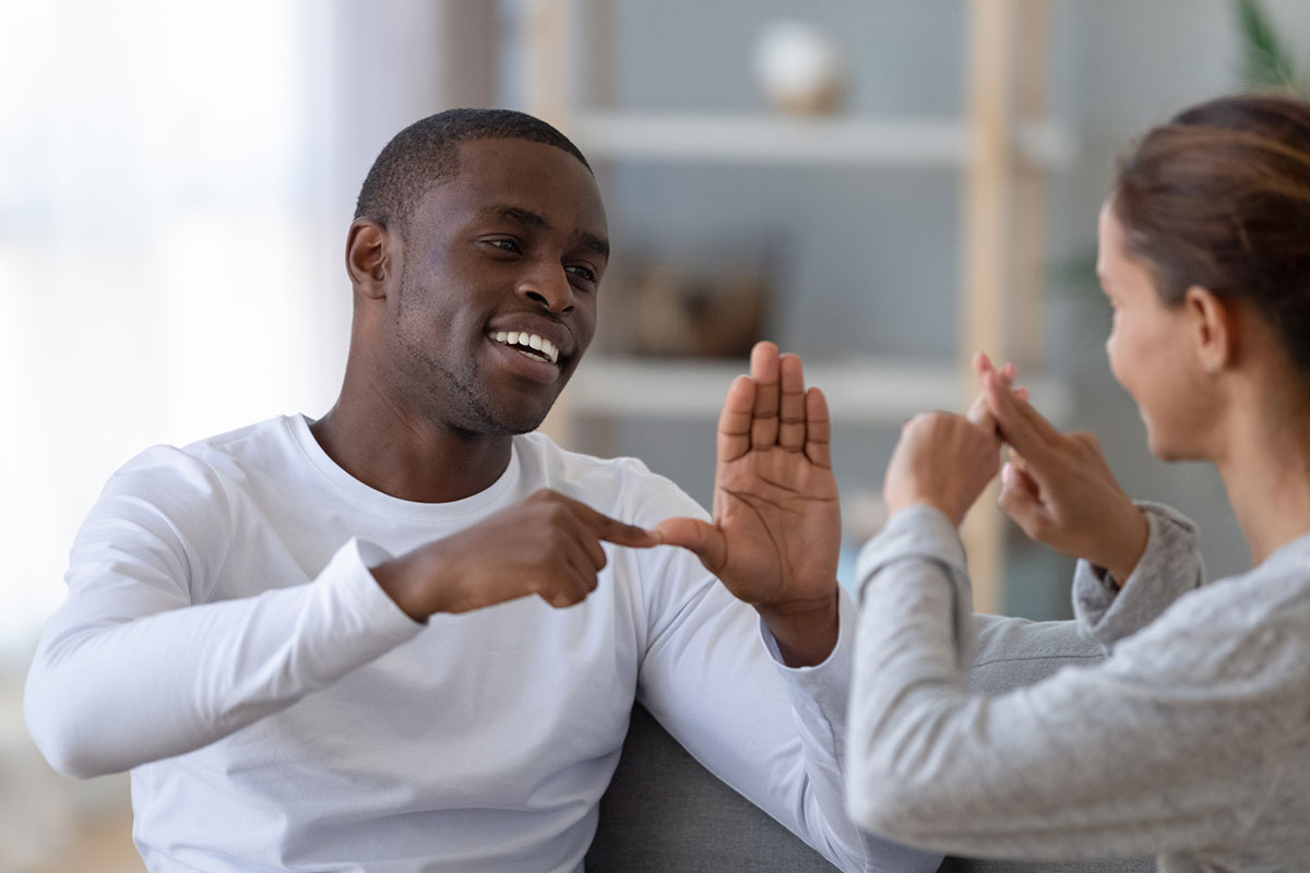 two people communicating via sign language