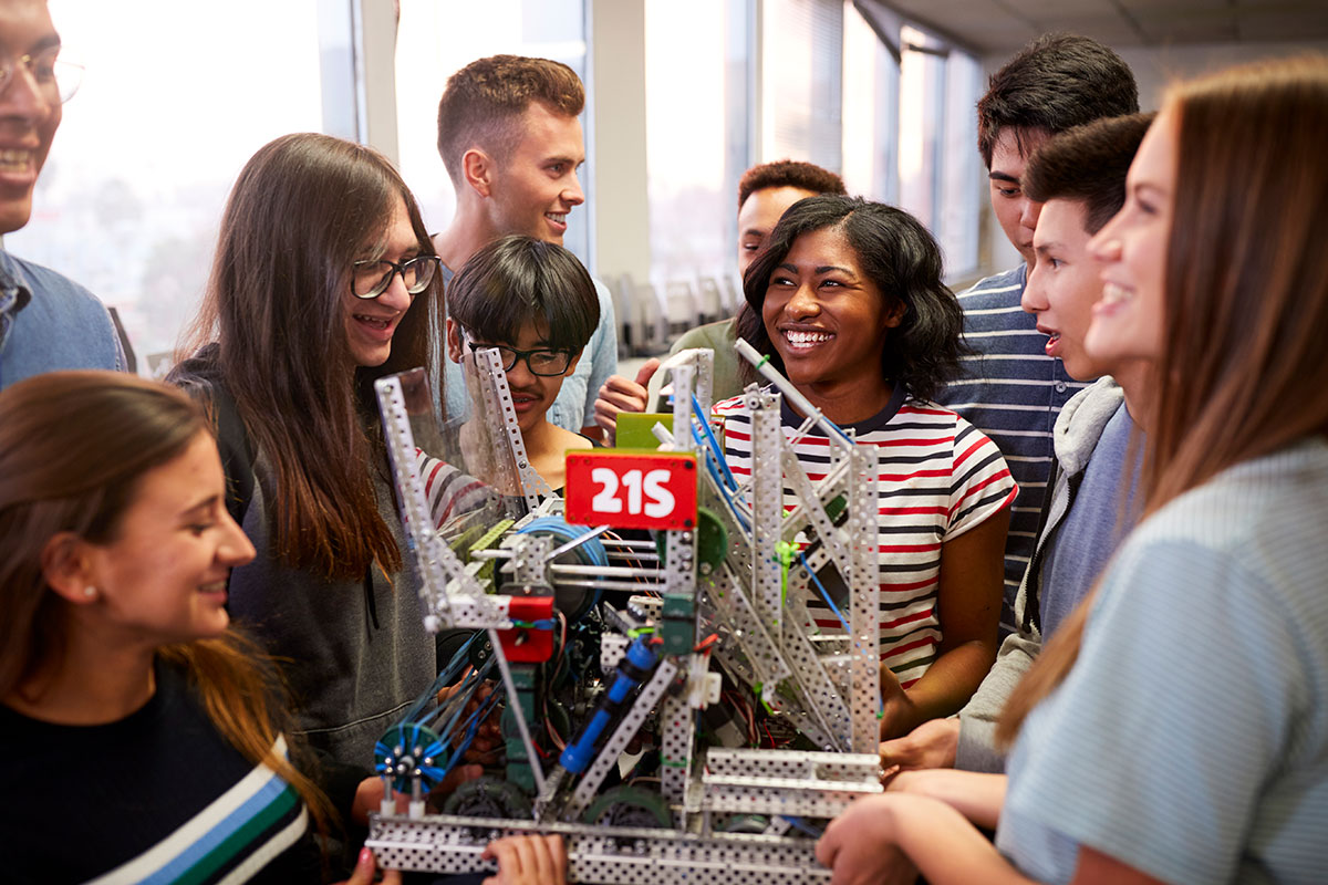 students gathered around an engineering example